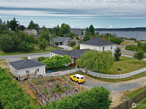 Aerial perspective showing the property's position relative to Penn Cove with water in the background